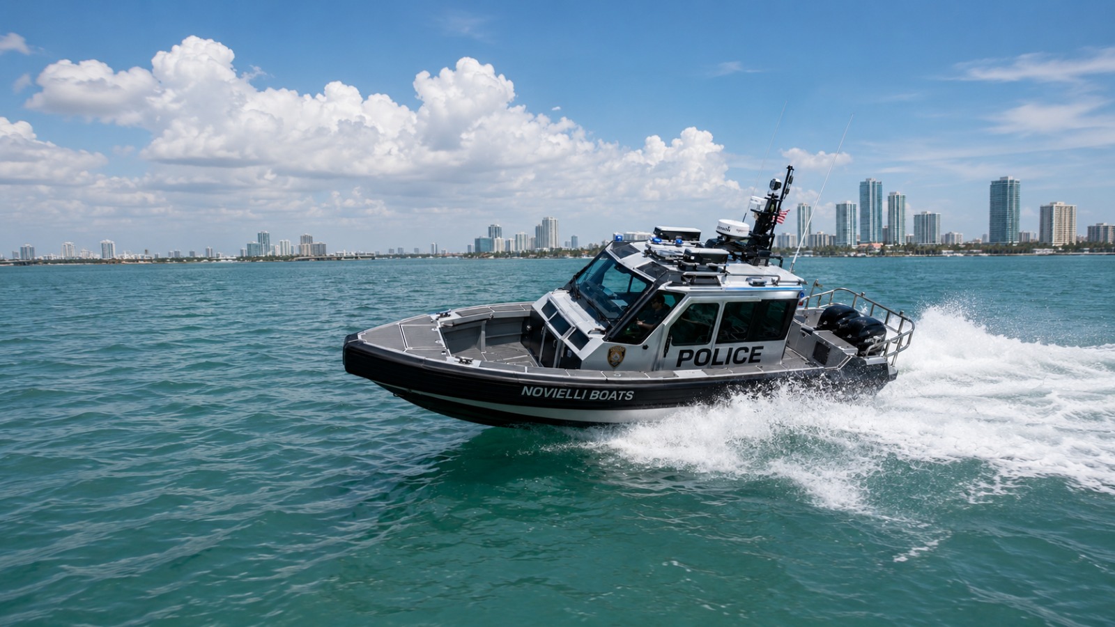 Novielli tactical police patrol boat running at speed on turquoise water with the Miami skyline behind.