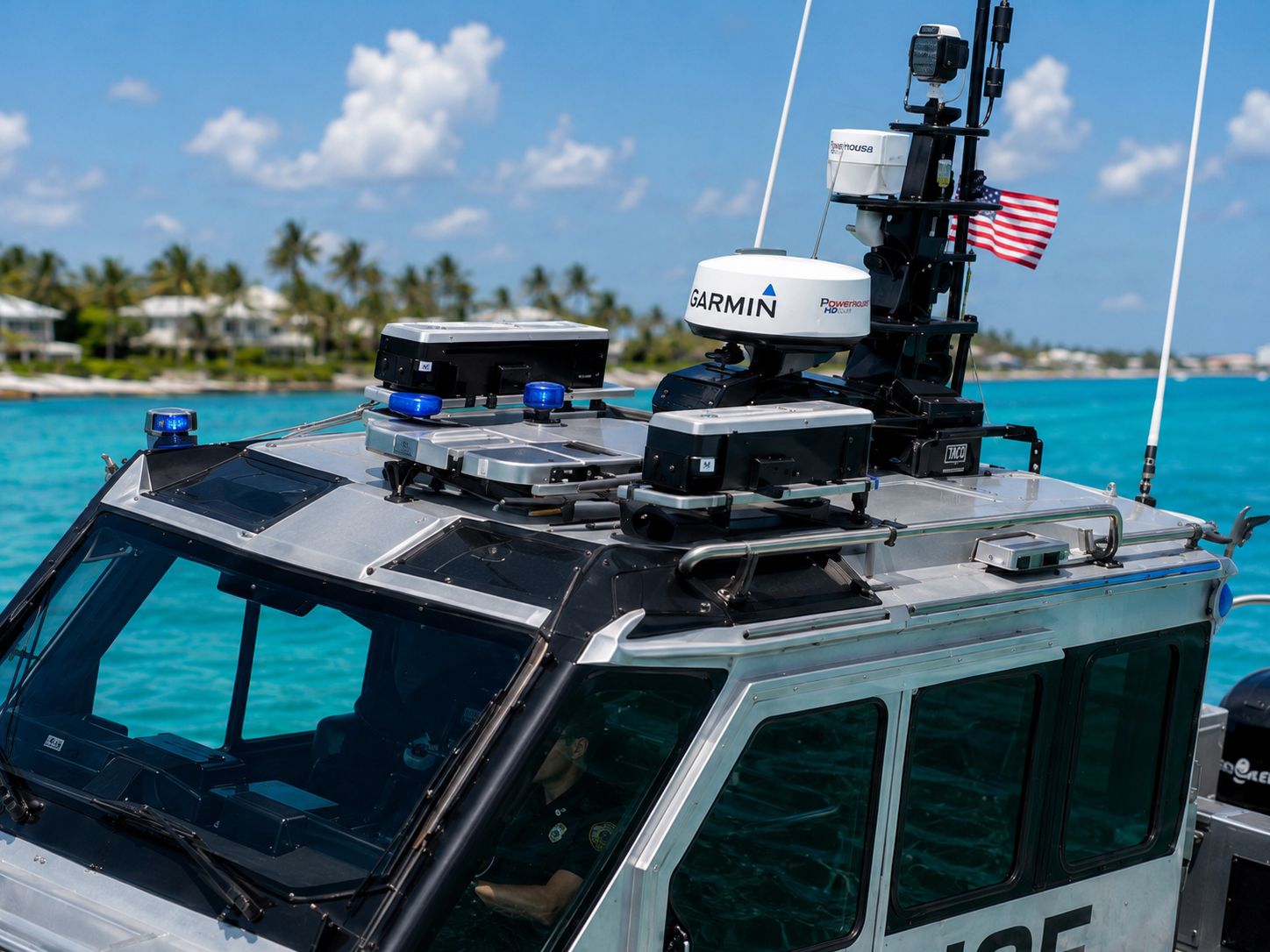 Close-up of the Obsidian 269 Interceptor pilothouse roof showing Garmin radar, FLIR thermal cameras, blue emergency beacons, and the antenna array.