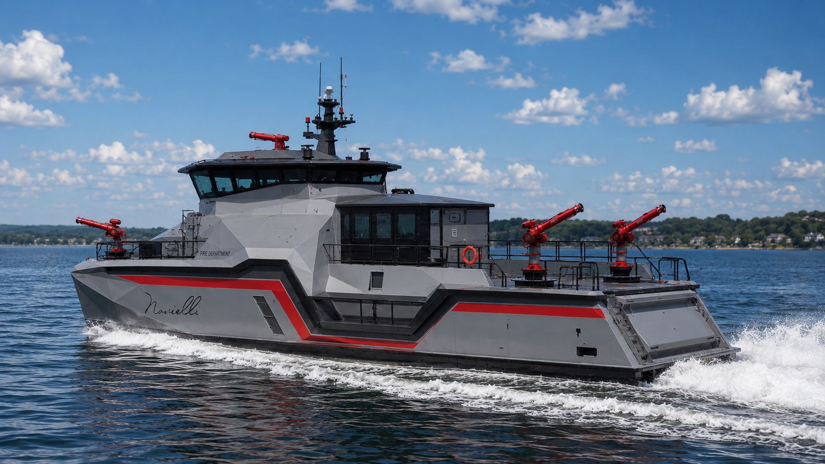 Stern-quarter view of the Inferno LR 829 underway with three aft fire monitors and FIRE DEPARTMENT lettering on the cabin.