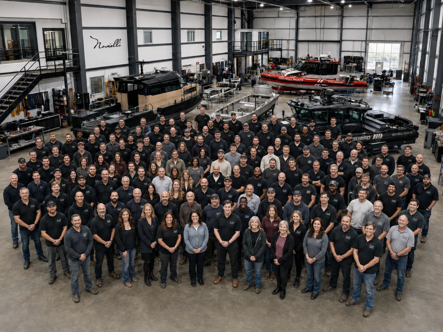 The full Novielli Boats team gathered inside the shipyard in front of finished vessels.