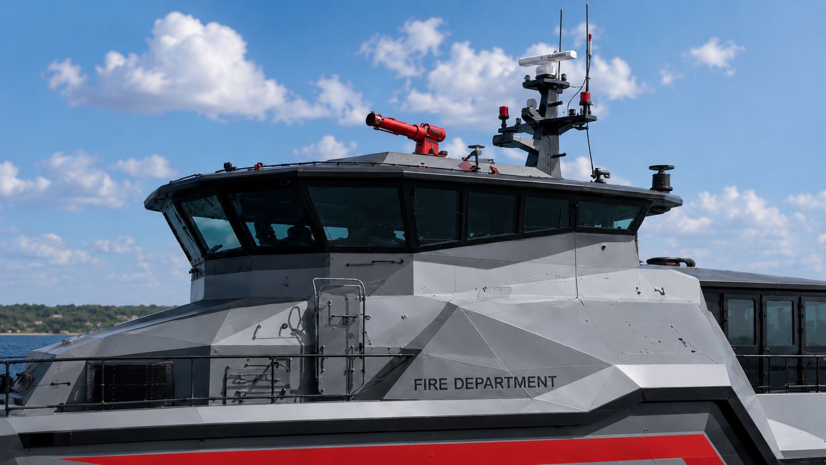Close-up of the Inferno LR 829 pilothouse and mast — Garmin radar, antennas, beacons, and forward red fire monitor against blue sky.