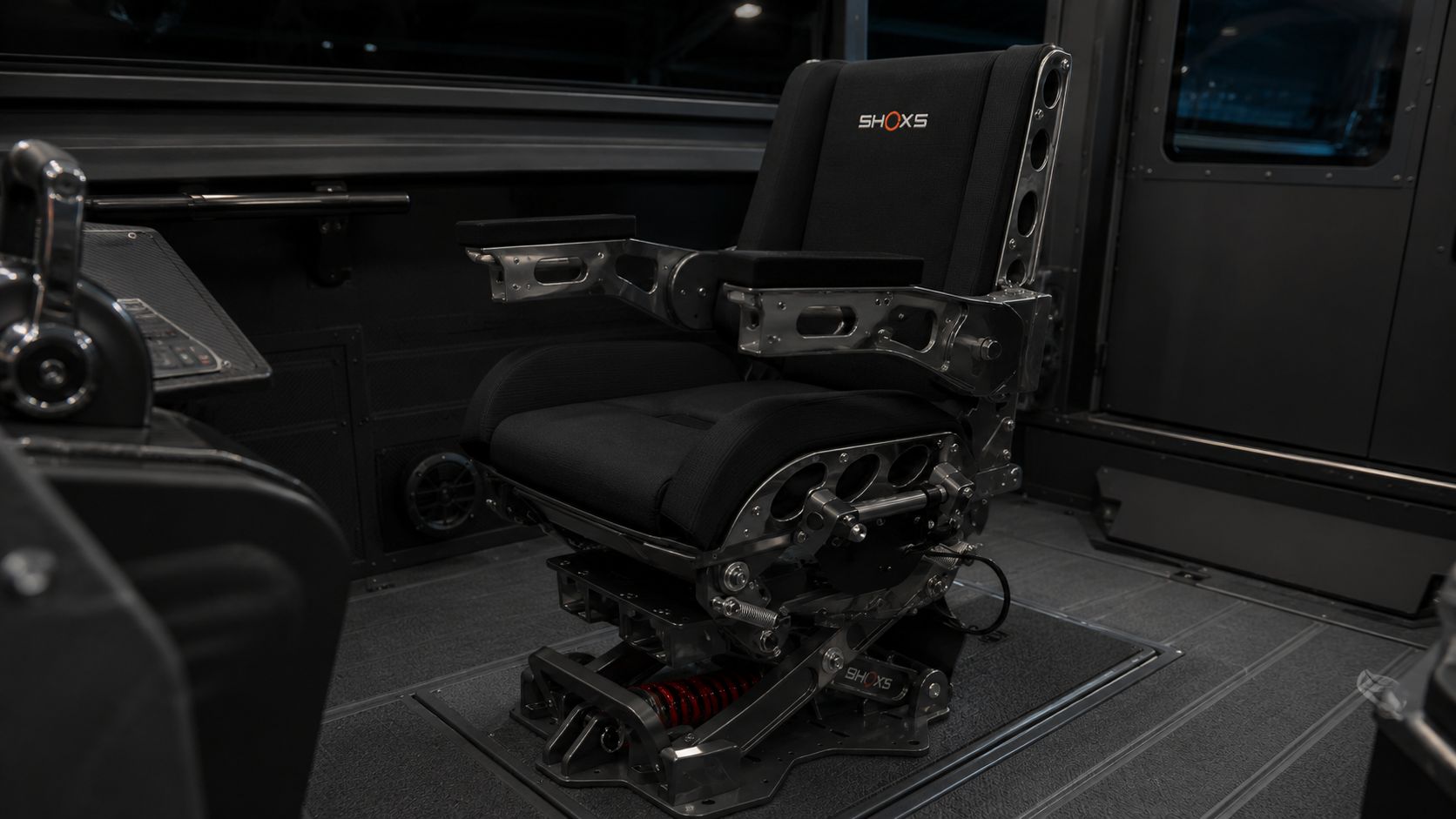 SHOXS shock-mitigating helm seat inside the Outlaw 559 LR pilothouse — black mesh seat on polished suspension frame mounted to a non-skid aluminum deck.