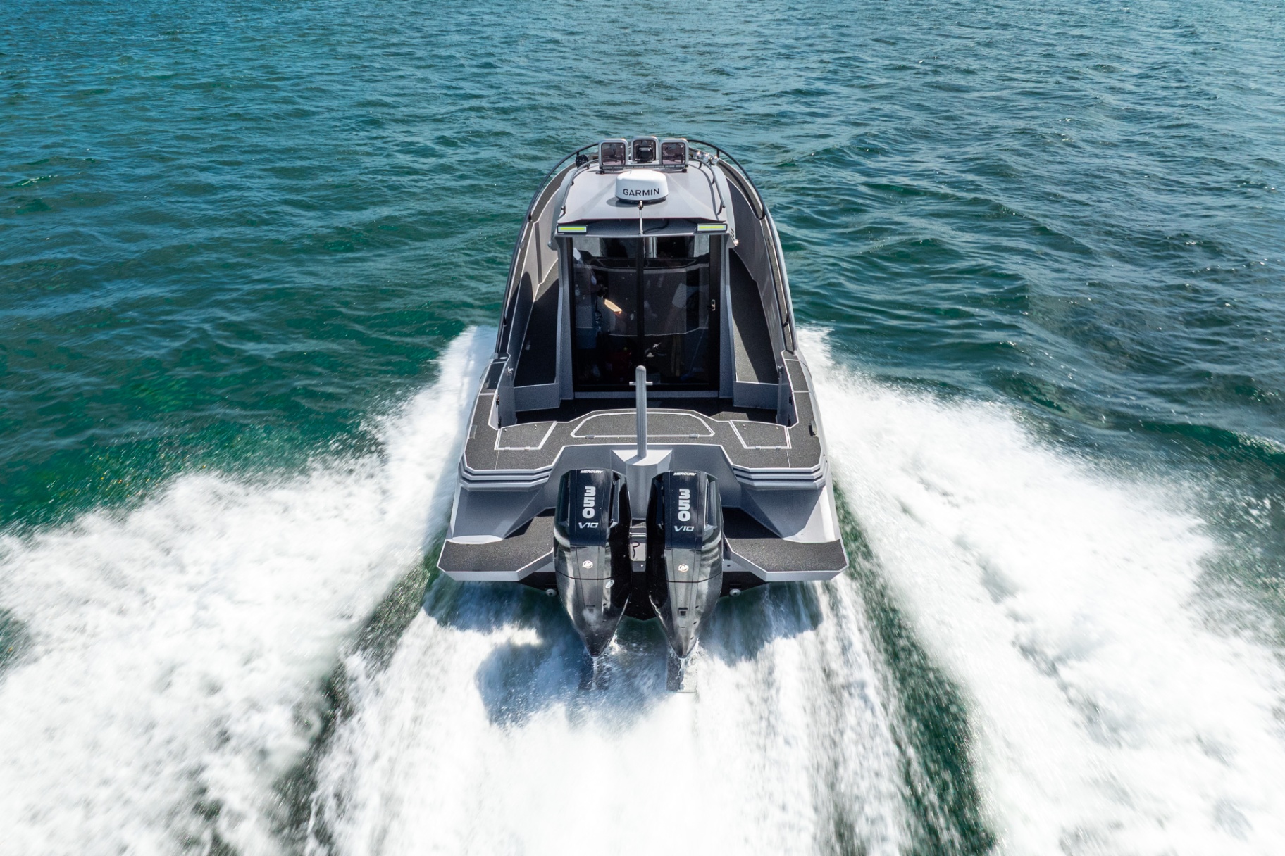 Aerial stern view of the CERE 369 Signature underway, twin Mercury V10 outboards carving a clean wake.