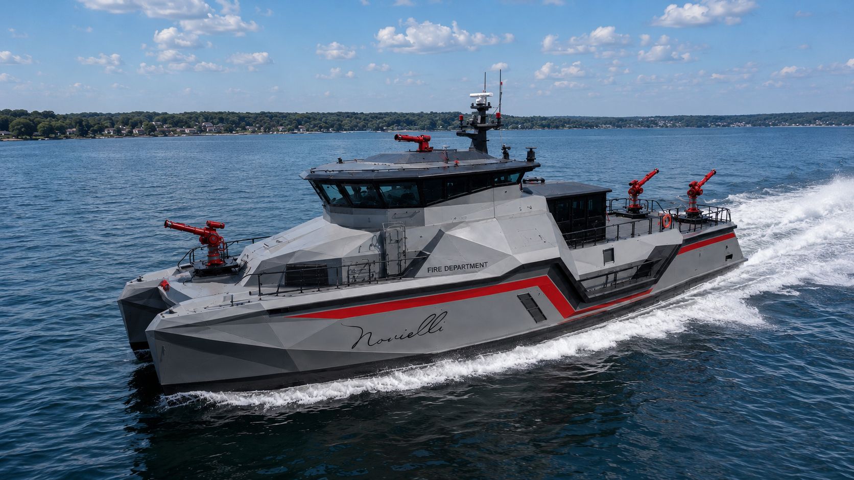 Aerial view of the Inferno LR 829 fire-rescue catamaran underway on open water, four red fire monitors deployed across bow and aft platforms.