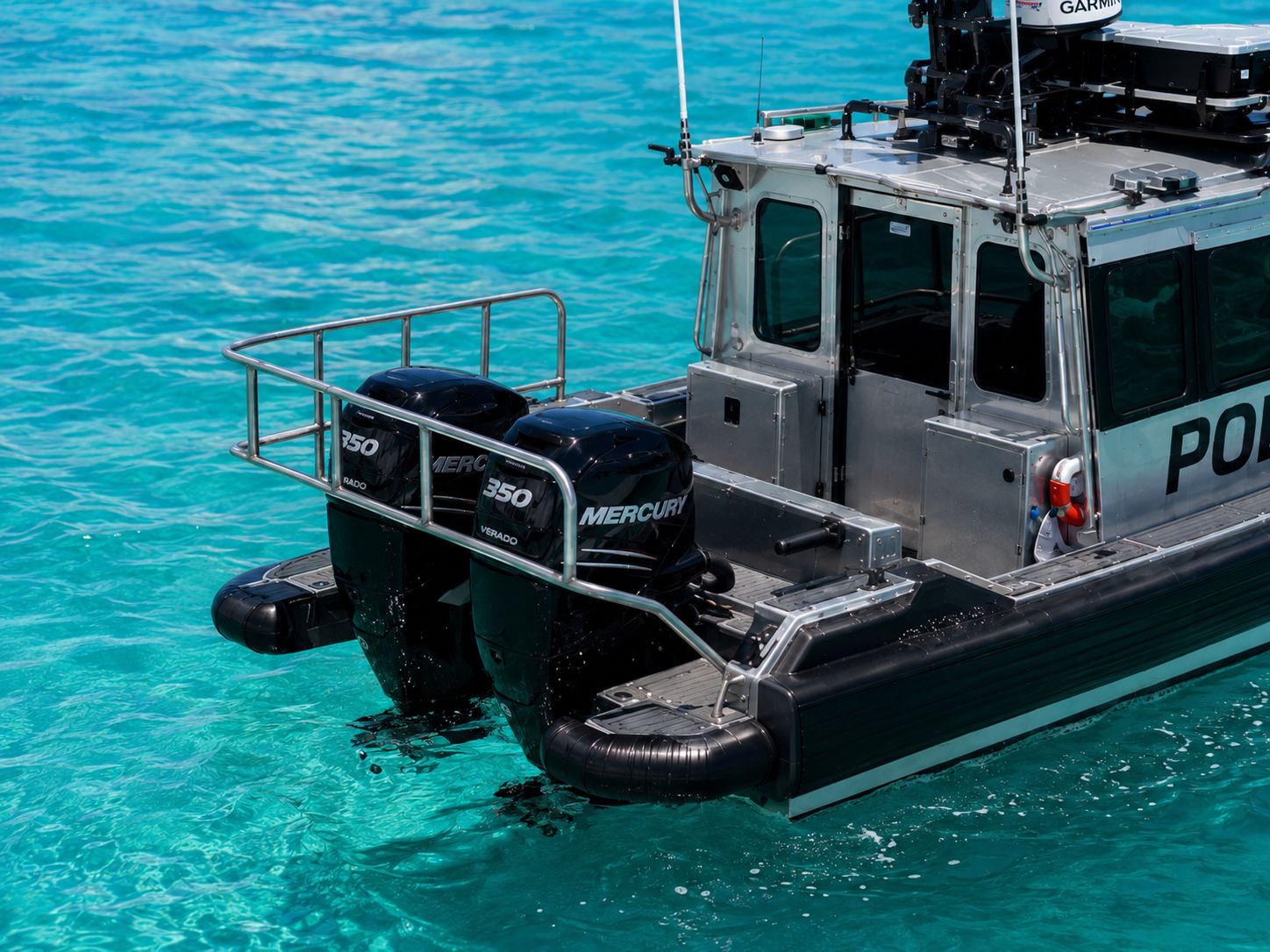 Detail view of the Obsidian 269 Interceptor stern with twin Mercury 350 Verado outboards, motor guard railing, and aft working deck.