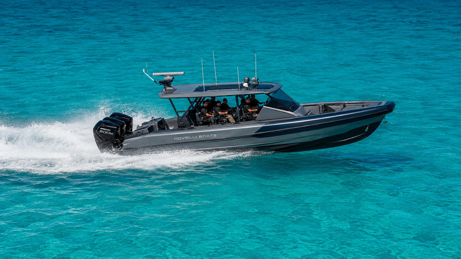 Novielli dark gray tactical interceptor with hardtop and twin Mercury 500R outboards running on turquoise water with a tactical crew aboard.