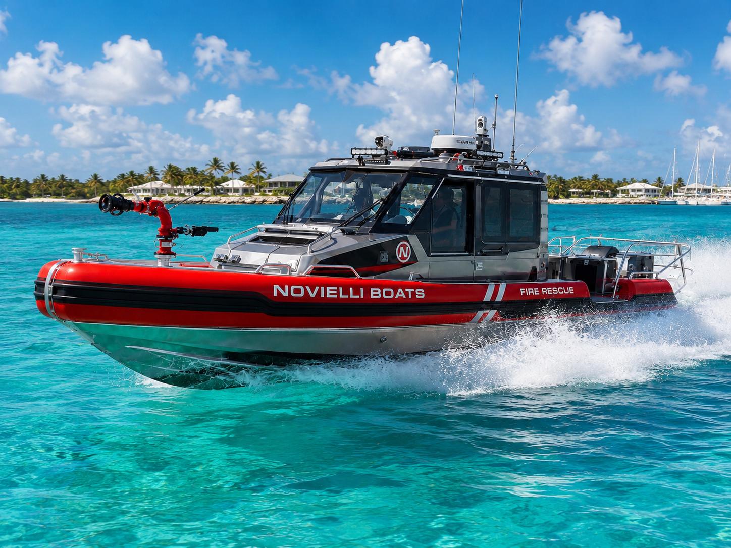 Novielli red fire rescue boat with water cannon running at speed on turquoise water near a tropical shoreline.